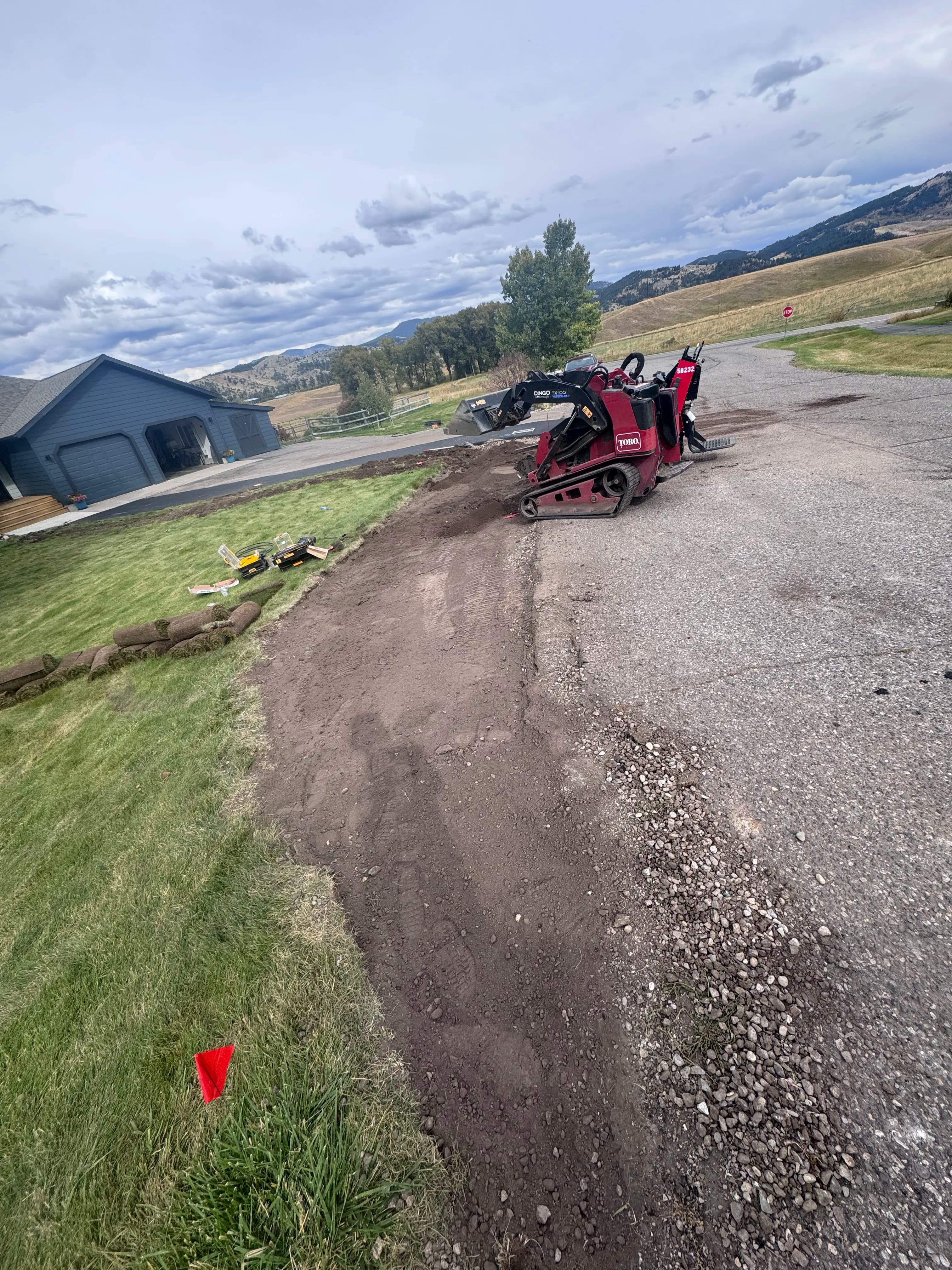 Project Dirt Work to Finished Sod Along a Driveway Edge image