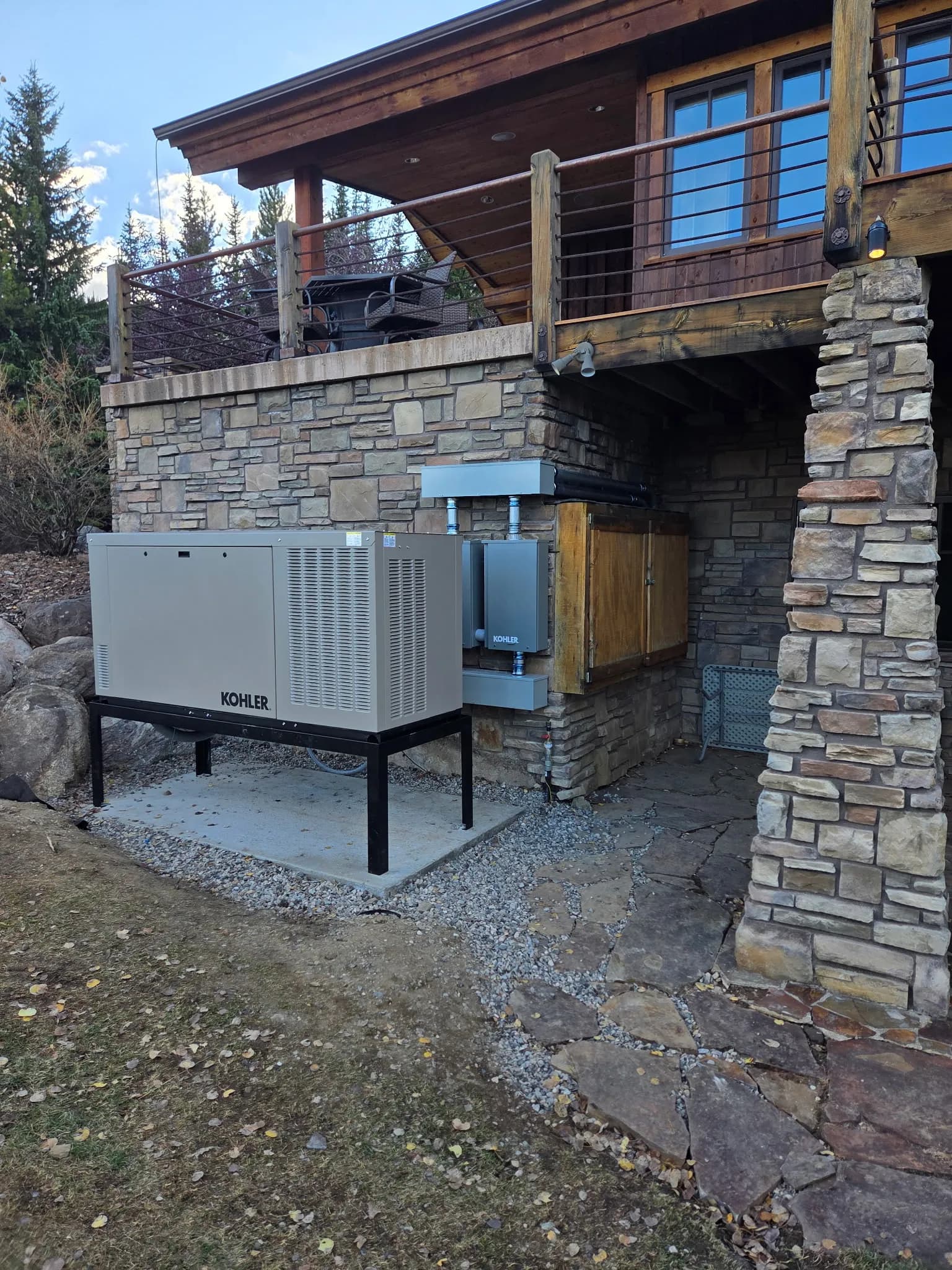 Concrete Generator Pad and Boulder Retaining Wall Built Right image